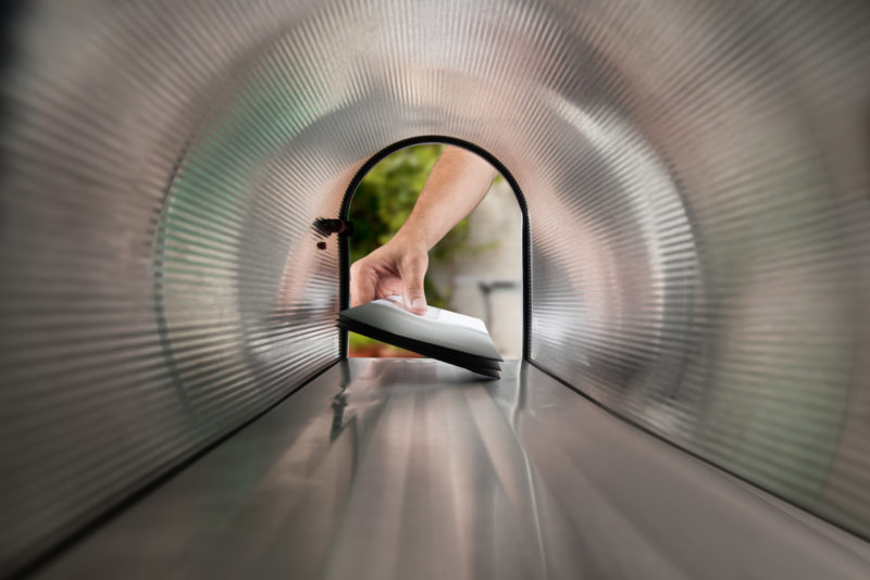 view from inside a mailbox as a person removes mail from it