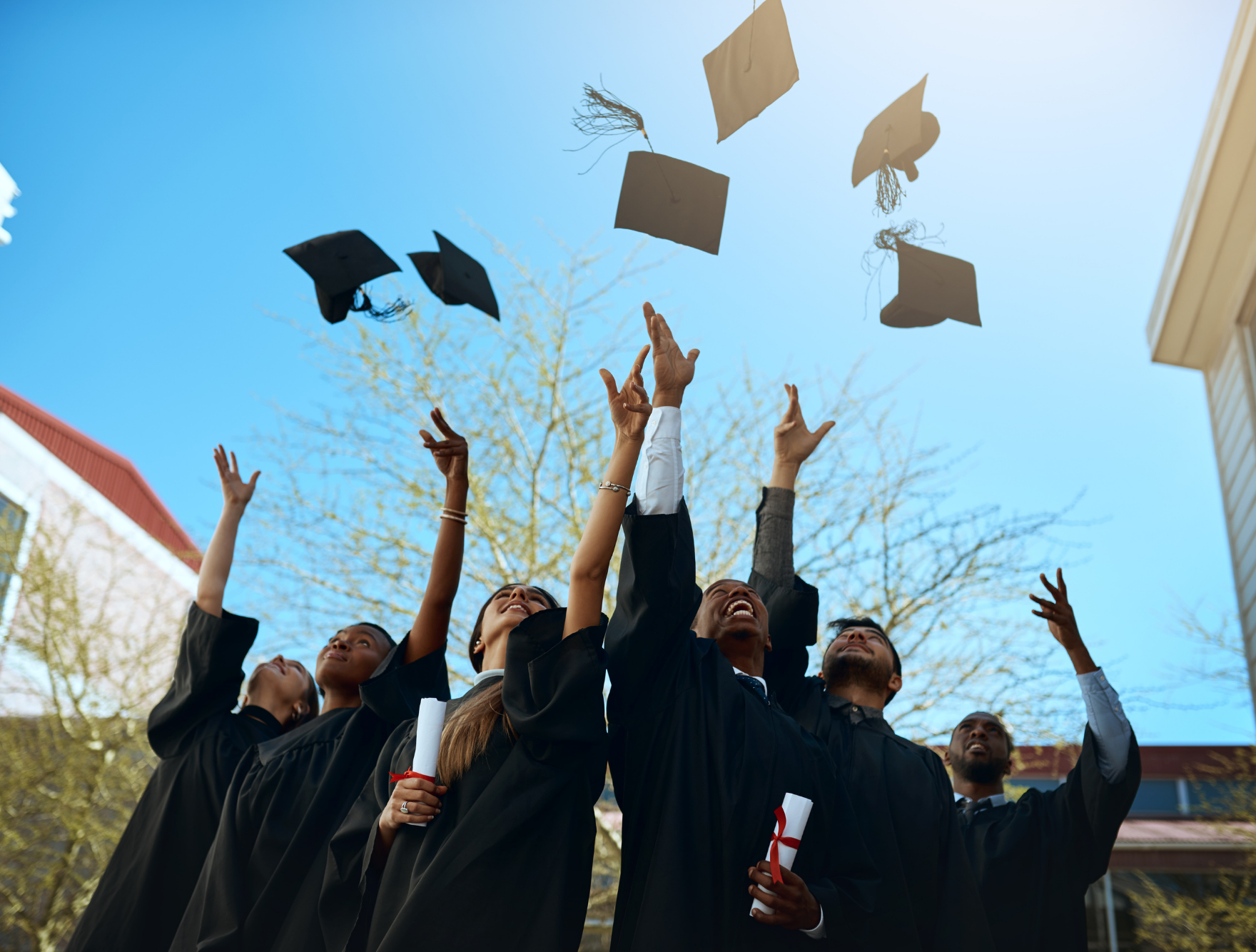 College graduates throwing their caps in the air