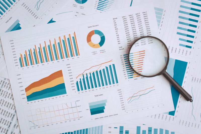 financial papers and magnifying glass